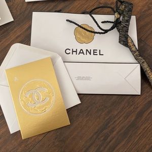 Chanel gift bag with gold Camelia and black/gold  ribbon with gold blank card.